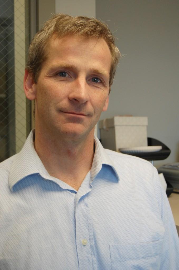 Professor Beveridge likes the playful aspect of math. Among other things, he studies pattern-based games from the simple tic-tac-toe to the more complex cops and robbers. Photo by Naomi Guttman ‘16