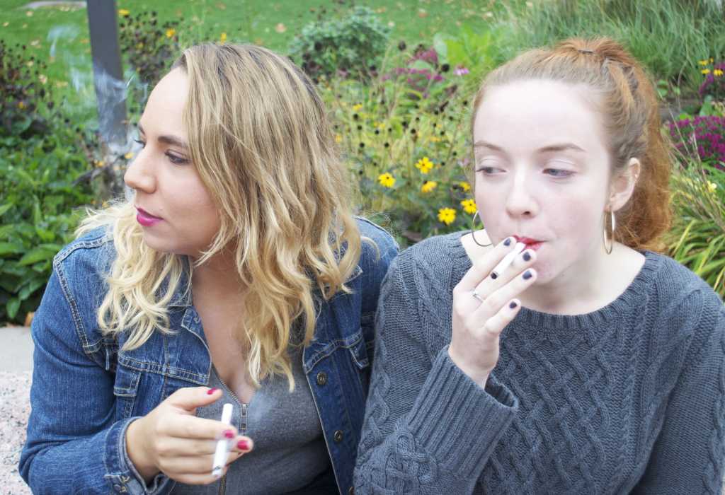 Alysha Alloway'17 and Mahala Miller'17 smoke outside the campus center. After January 1, this will be banned. Photo by Joe Bermas-Dawes'17.