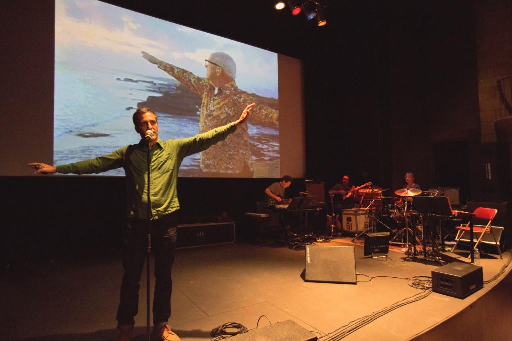 Sam Green, the director, narrates in the foreground, while Yo La Tengo accompanies with music. Photo Courtesy of Film Press Kit. 