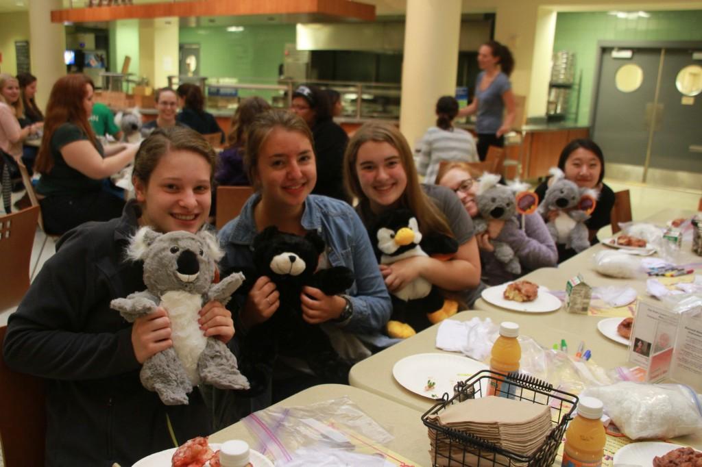 Macalester students hold up the “critters” they made at a Mac @ Nite this semester. Both events brought students together to eat and hang out on a Saturday night.