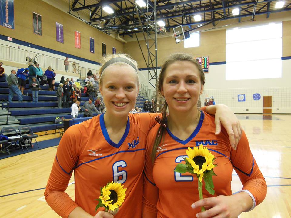 Bailey Rehnberg ’14 (left) and Laura Avena ’14 (right) were recognized on Senior Night for their four years of commitment to the program. Photo courtesy of Macalester College Volleyball. 