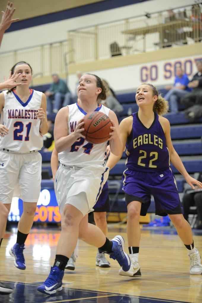 Taylor Pike ’14 drives to the hoop during a game last season. Pike was third on the team in scoring last year and is one of seven returning seniors for the Scots. Photo courtesy of Christopher Mitchell.