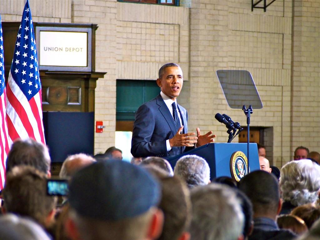 President Barack Obama speaking to a crowded Union Depot on Wednesday, Feb. 26. Roughly 1,300 were in attendance and heard the president’s announcement of competitive federal grants for infrastructure development in cities around the United States. Photo by Jesse Meisenhelter 