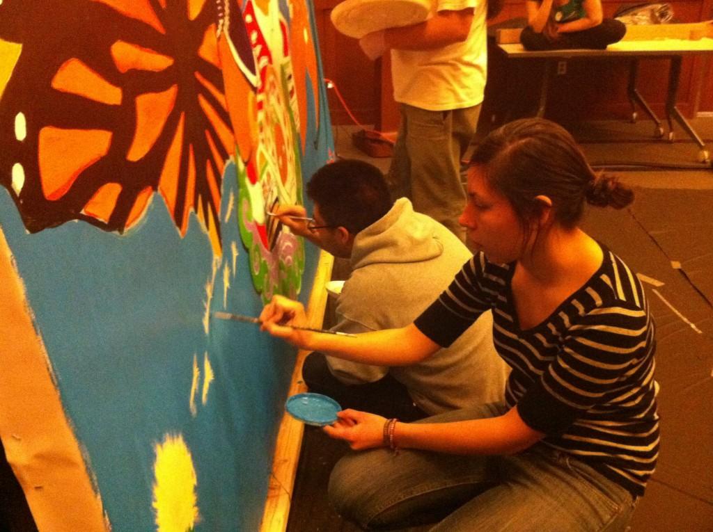 Adan Martinez ’16 and Jessica Muñoz ’14 help paint a mural as part of this Adelante!’s annual Latin@ Week. The campus-wide celebration focused on exploring questions of migration and belonging through the arts. The week incorporated the above mural, made with the help of local muralist Gustavo Lira, as well as a documentary film screening, dance and music. Photo courtesy of Adan Martinez ’16.