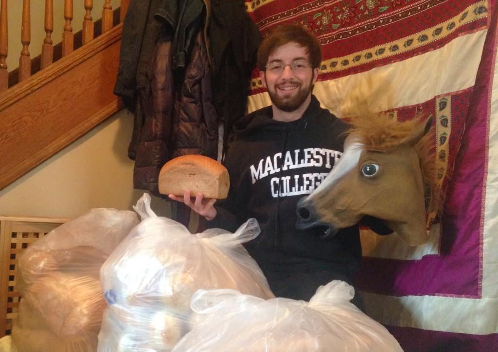 The legendary Horseman of Macalester, Evan Myers ’14, shows off his famous mask and loaves of fresh bread. After receiving the mask as a gift, Myers started his career at Kagin, and expanded to the library, Winter Ball, and even Facebook. Photo courtesy of Evan Meyers ’14.