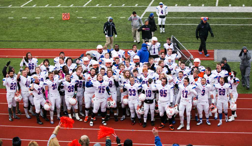 Last Saturday for the first time in 67 years, the Macalester Football team hoisted a conference championship trophy. The Fighting Scots defeated Illinois College 30-27 to wrap up the Midwest Conference and secure a spot in NCAA Playoffs. The victorious post-game song has become quite a common occurrence this season as the Scots have won eight consecutive games, setting a school record. On Saturday, Nov. 22 they will face the defending national champions UW-Whitewater in the opening round of the NCAA Playoffs. Photo courtesy of Steve Frommell.