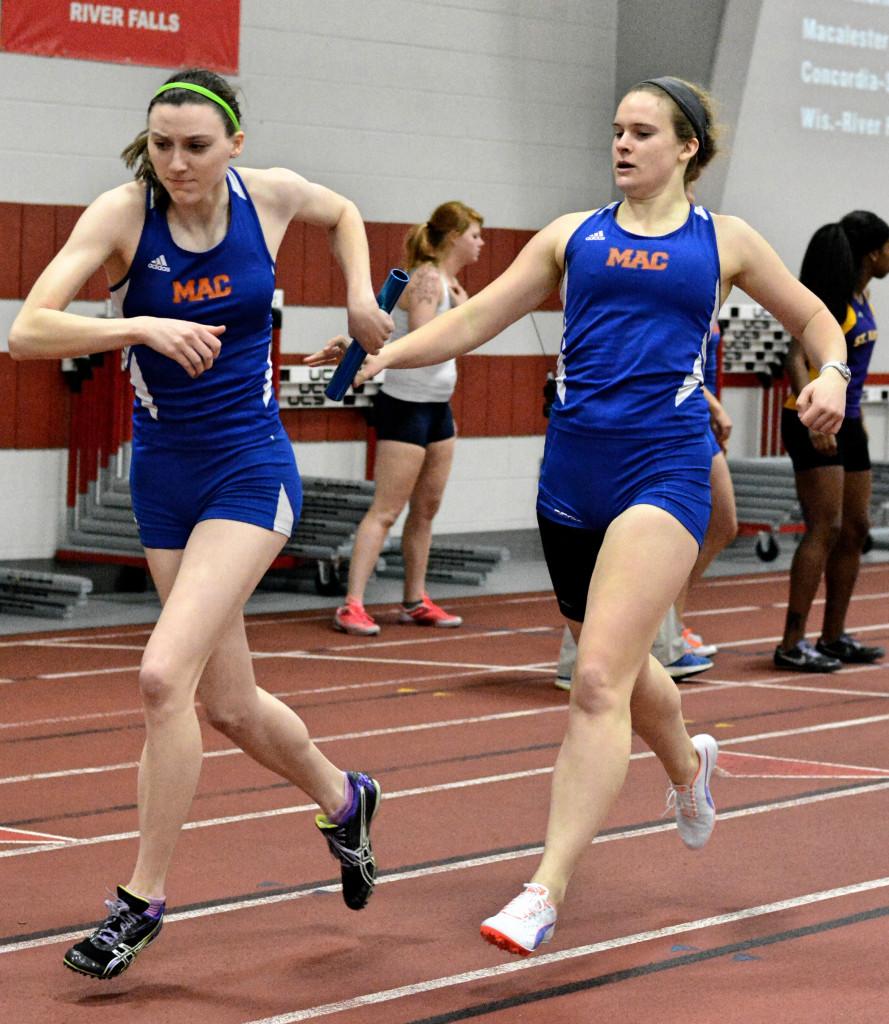 Erin Ortiz15 hands the baton off to Hannah Sonsalla18.  Both are members of Macalesters conference championsihp bound 4x200 and 4x400m relays.  Photo by Anders Voss16.