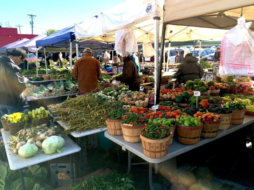 The Sun Foods Hmong Market (above) offers fresh fruit and vegetables at affordable prices, such as the bucket of eggplant (lower right) for $5.*Photos by Ashley Hung ’16.*