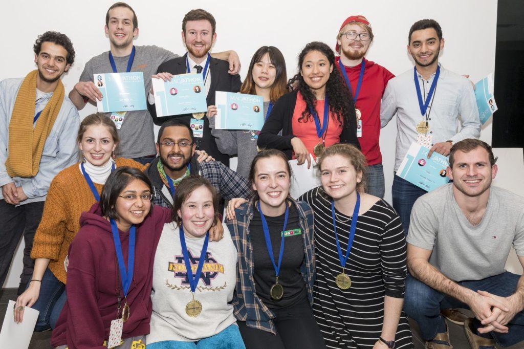 Members of Macathon teams “7bibi” and “Cobenesoka” and the Funkathon team “Moonbinch and the Belligerent Earth Girls” gather following their respective wins on Saturday night. Photo courtesy of Macalester College.