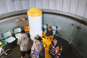 Macalester’s Physics and Astronomy club seniors pose in front of the telescope in Macalester’s observatory. From left to right, Brian Eisner ’18, Catie Ball ’18, Alex Gordon ’18 and Liz Ruvolo ’18.  Photo by Marin Stefani. 