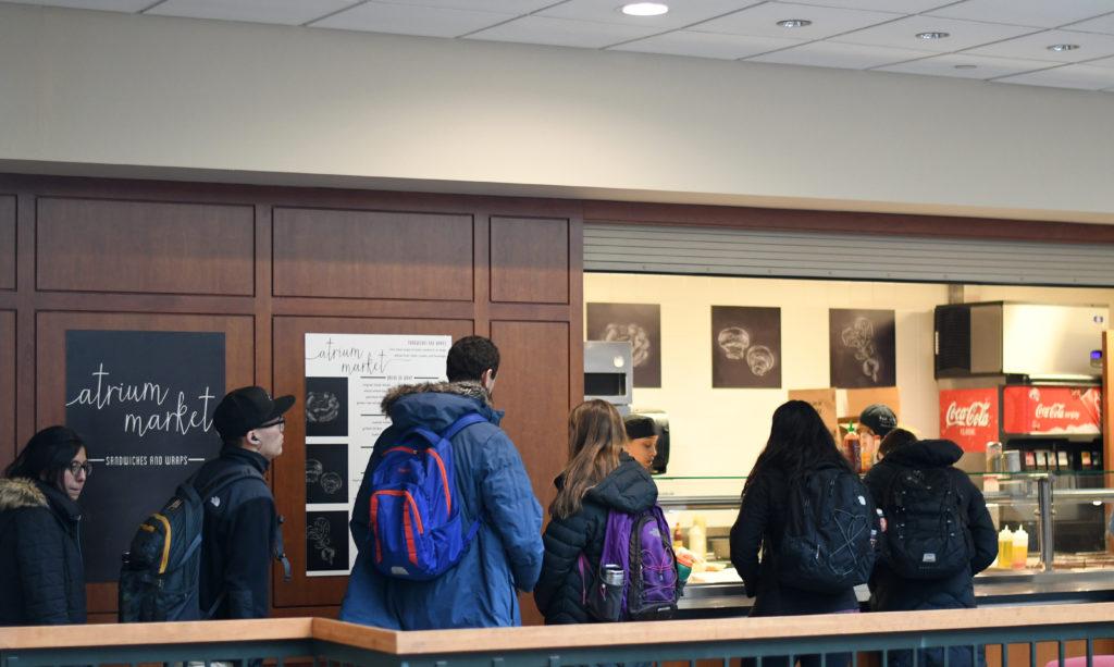 Students wait in line at the Atrium Market, where Gerald Booker spent the last years of his Macalester career. Nearly 1,000 people have signed a petition asking the college to rename the market in his honor. Photo by Maya Rait ’18