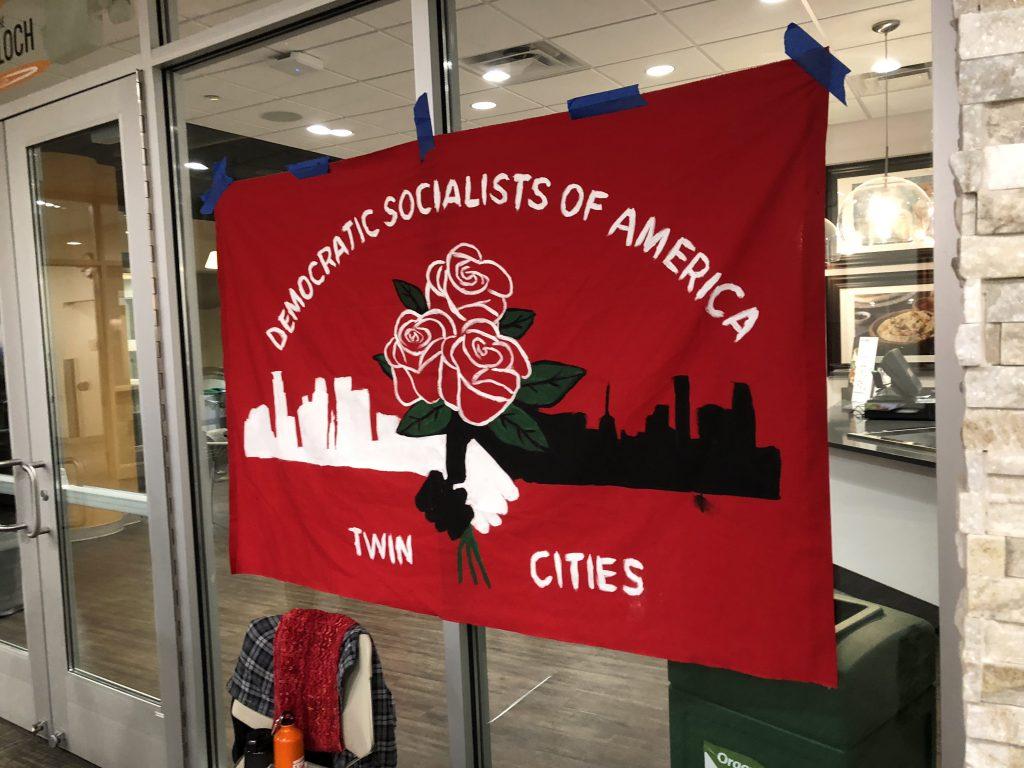 A Twin Cities DSA flag hangs outside of John B. Davis Lecture Hall. Photo by Abe Asher ’20.