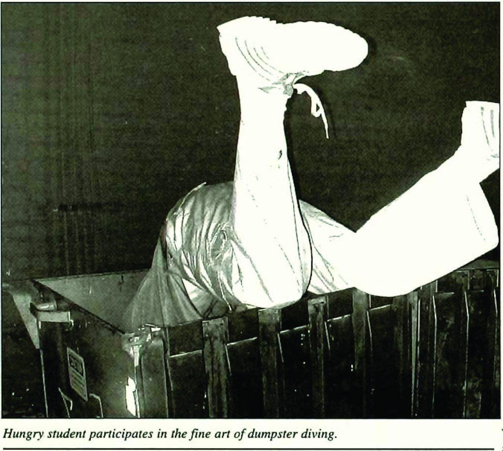 A past Macalester student partakes in dumpster diving. Photo courtesy of Macalester Archives 