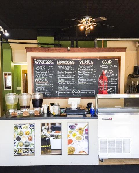 The front counter, assortment of drinks and menu at Zait & Za’atar. Photo by Ben White ’21.