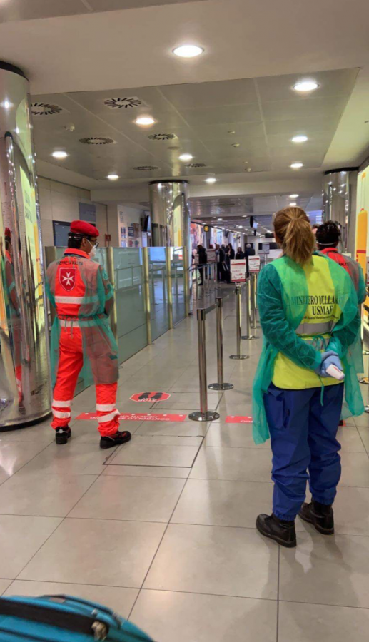 Employees wearing protective clothing inside an airport in Florence, Italy. Photo by Emma Janiszewski 21