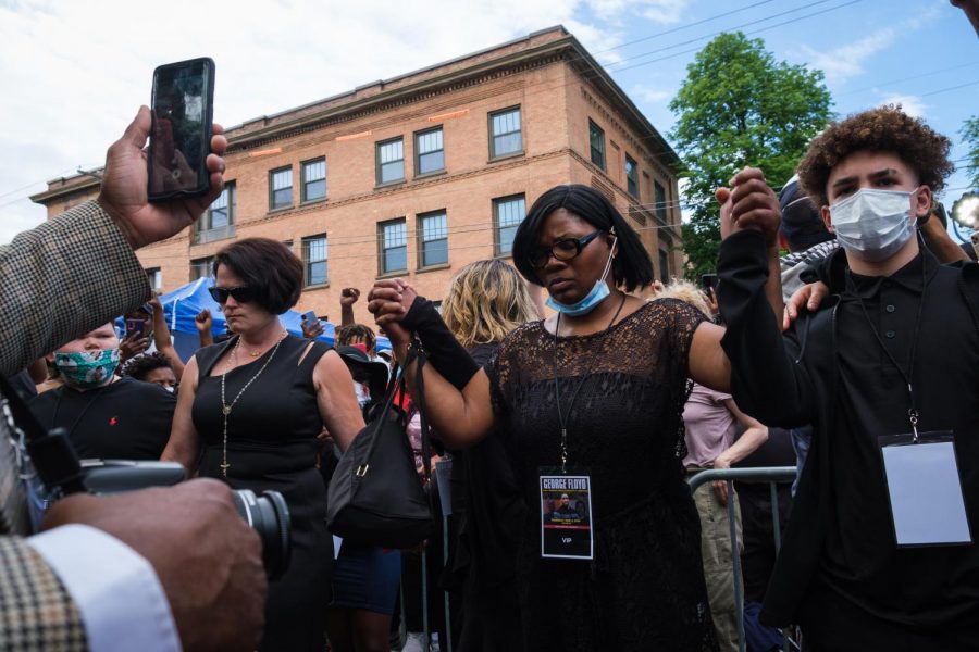 Mourners join hands outside of North Central University, where a memorial for George Floyd was held on June 4th. Photo by Kori Suzuki 21.