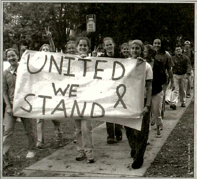 Excerpt from the Mac Weekly Sept. 21, 2001 issue. The original caption reads, Macalester athletes and other students participate in a march to show support for victims of last weeks tragedy, including people of Middle Eastern descent who have been targeted. Courtesy of the Macalester Archives.