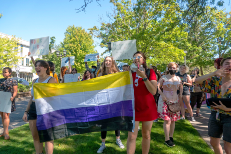 Students display LGBTQ flags and signs in counter-protest.