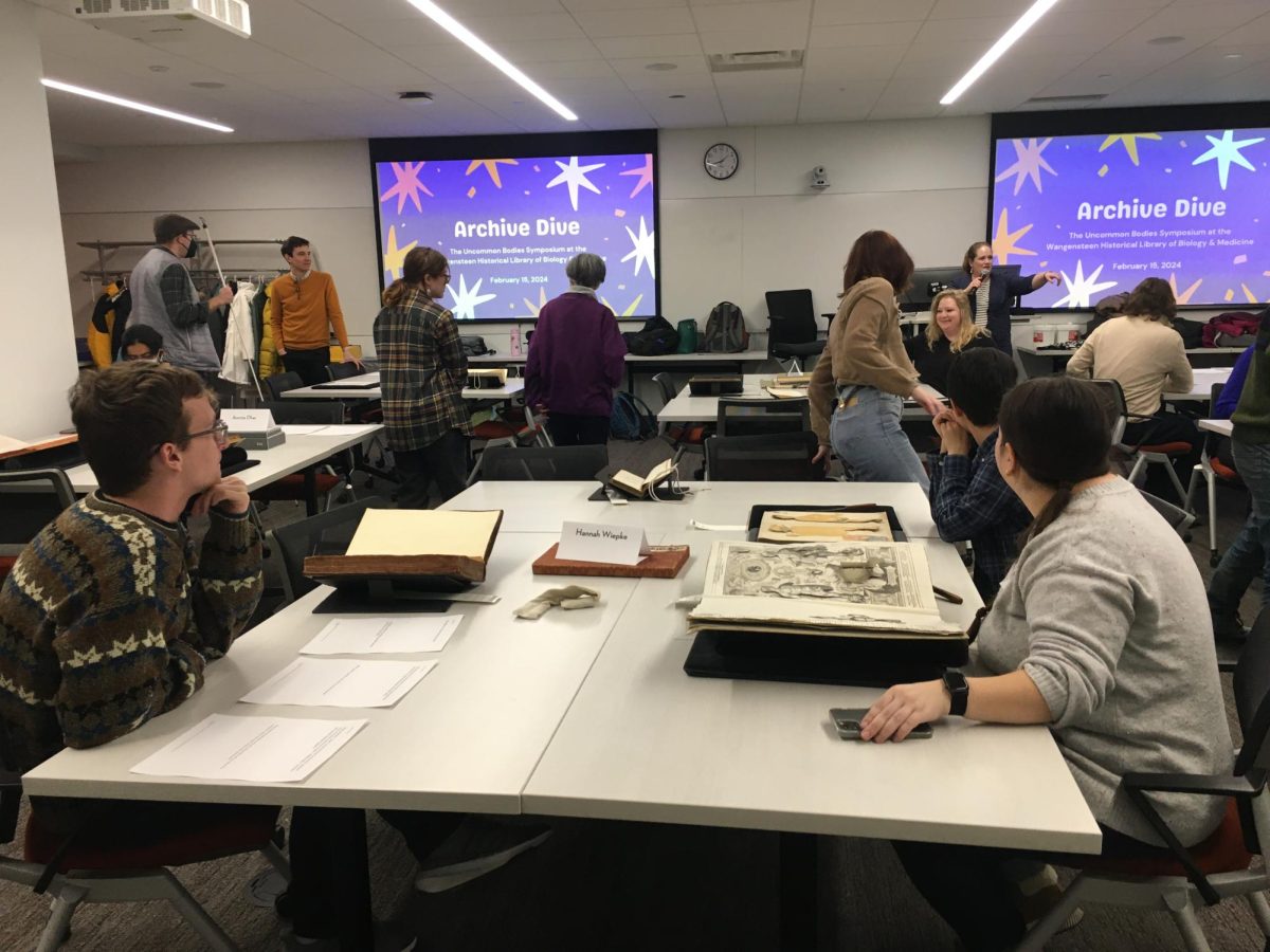 Symposium attendees engage in archive dive at University of Minnesota. Photo courtesy of Penelope Geng.