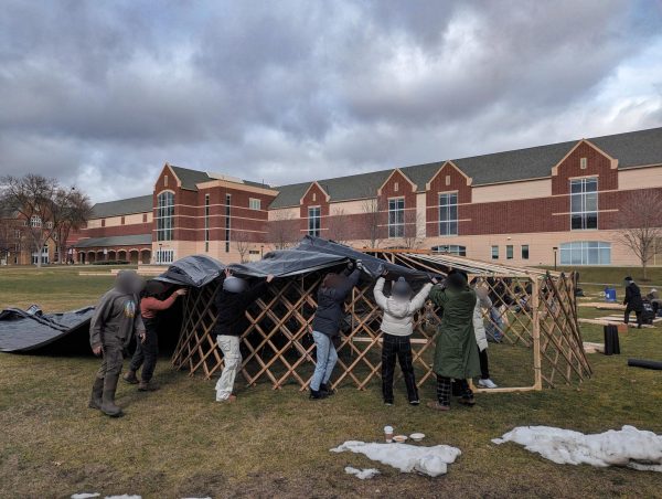 Macalester students and community members work together to build yurt. Photo courtesy of John Kim.
