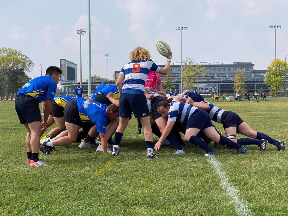 Scrumhalf Sam Stevens '27 prepares to start a scrum. 