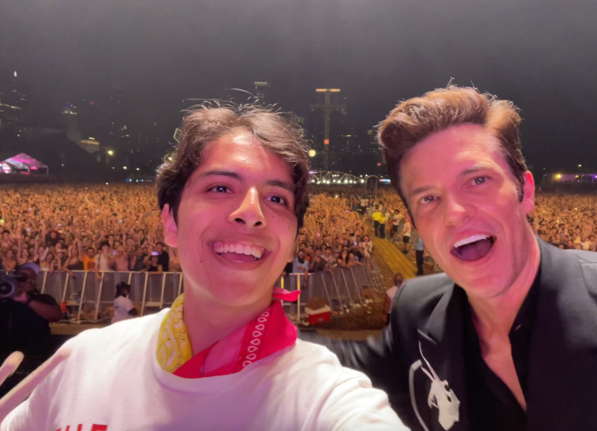 Oscar Reza Bautista and Brandon Flowers on stage at Lollapalooza