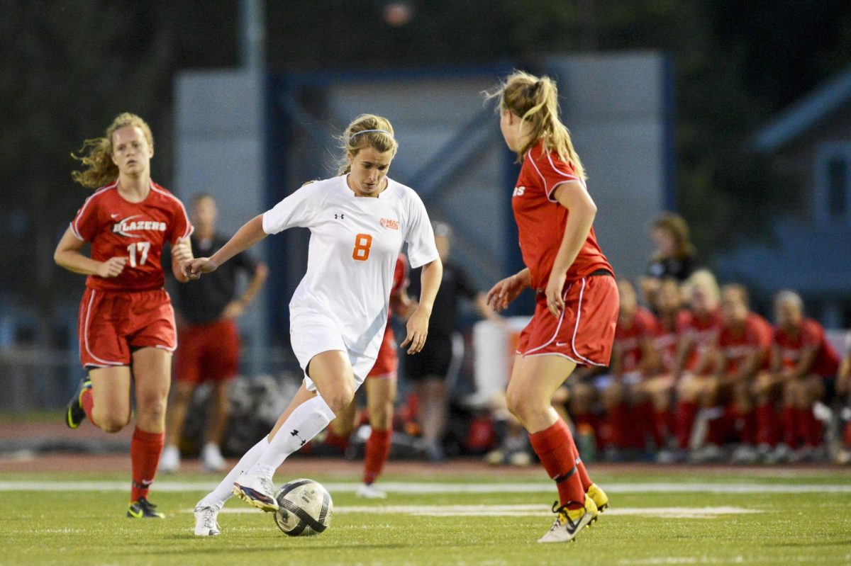 Cloepfil dribbles against St. Ben’s in 2012. That year, she scored 15 goals and was
named team MVP. Photo Courtesy of Christopher Mitchell ’01 / Sports Shot Chris.