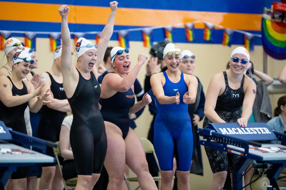 The women’s medley relay team celebrates a win. Photo courtesy of Mac Athletics