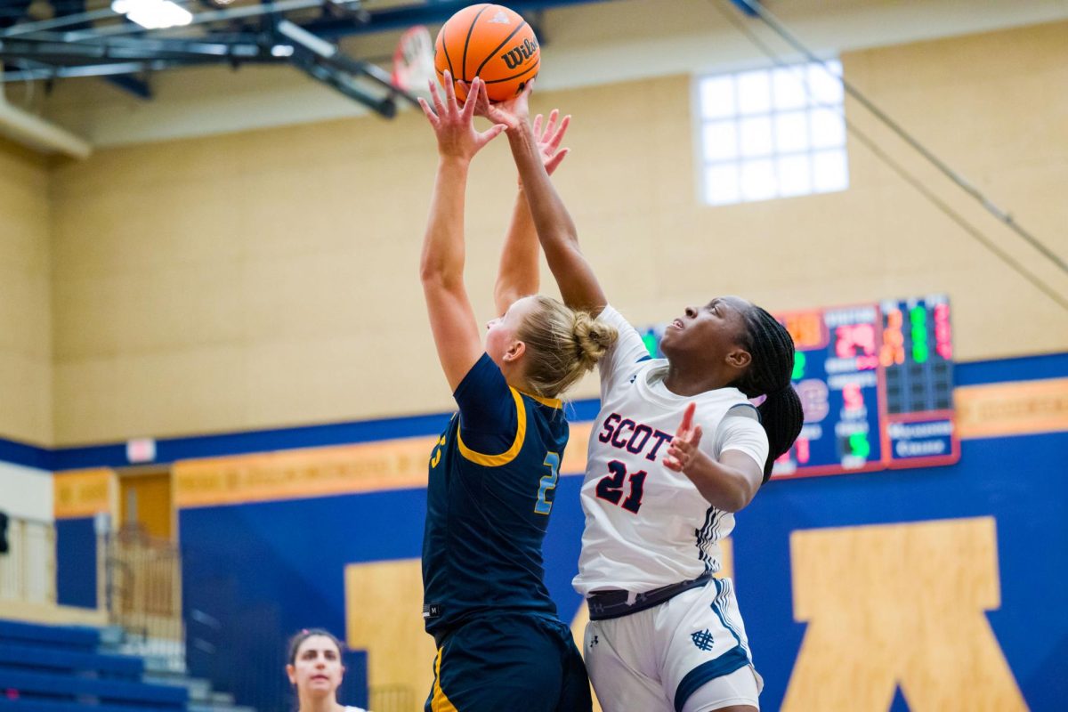 Sydnee Smith ’27 skies for the block against the College of St. Scholastica. Photo by Chris Mitchell ’01, Sport Shot
Photo.